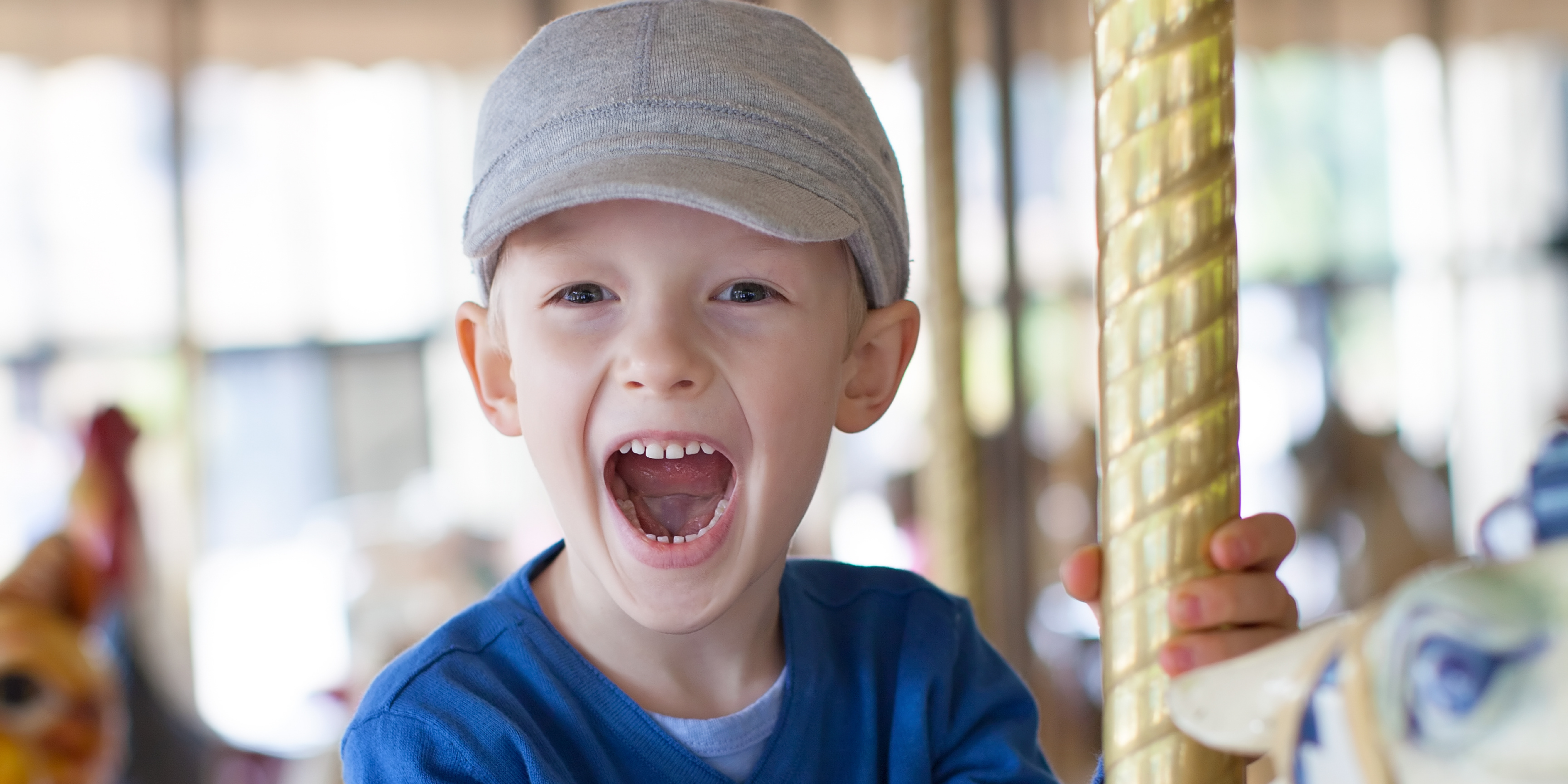 4 child enjoying himself on a carousel